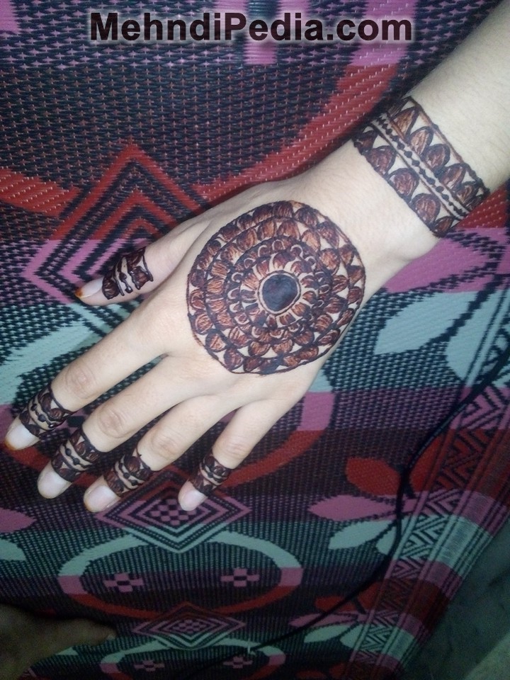 Centrally placed circular henna design for back and front hand